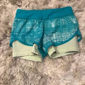 Size 12 ivivva blue and green shorts with a pocket